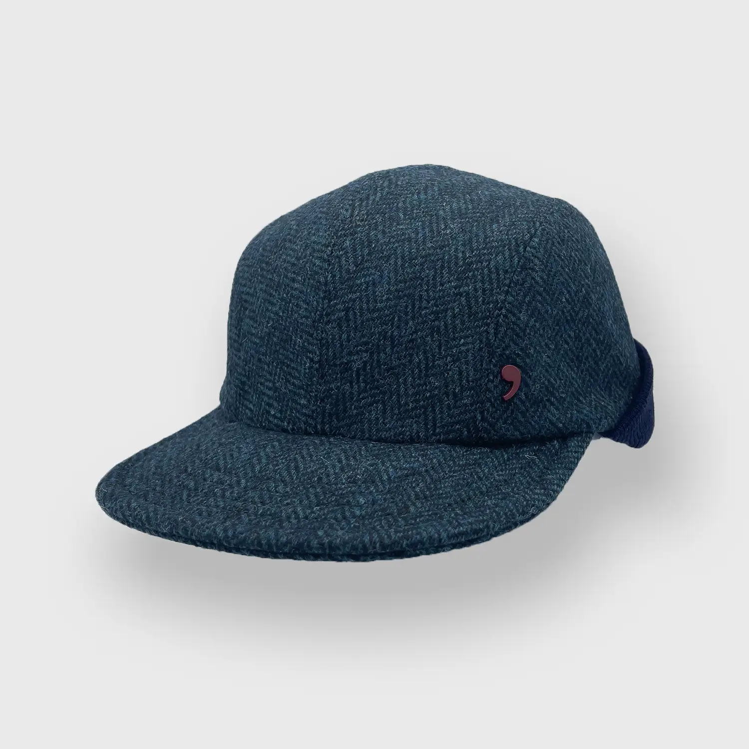 Pet in tweed met visgraat patroon getilt.