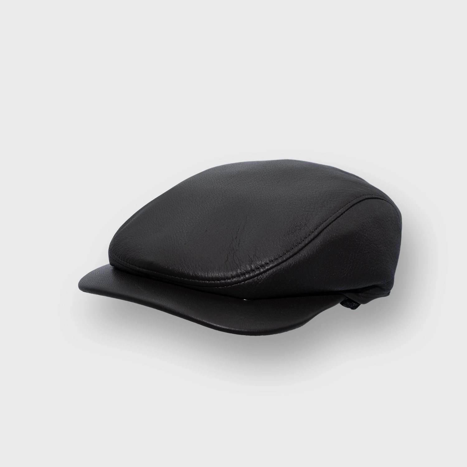Casquette plate The handler de Wigéns, cuir premium, à rabats d'oreilles, incliné