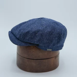 Newspaper boy flat cap in blue with gray flecks.